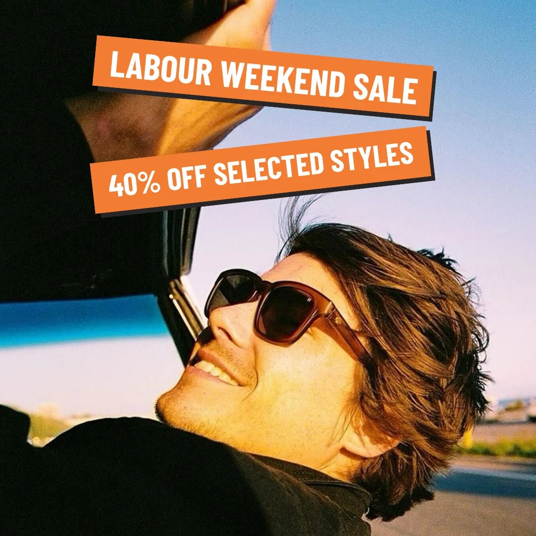 Man in Spy sunglasses smiling out of a car window. Labour Weekend Sale, 40% off selected styles.